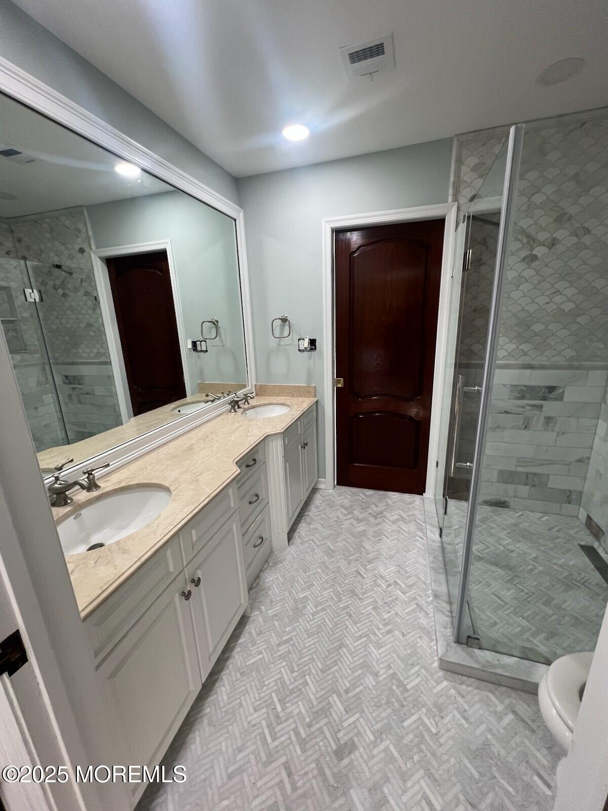 220 Pointe Drive Mantoloking, NJ 08738 - Photo 18 of 30 a bathroom with a double vanity sink toilet and shower