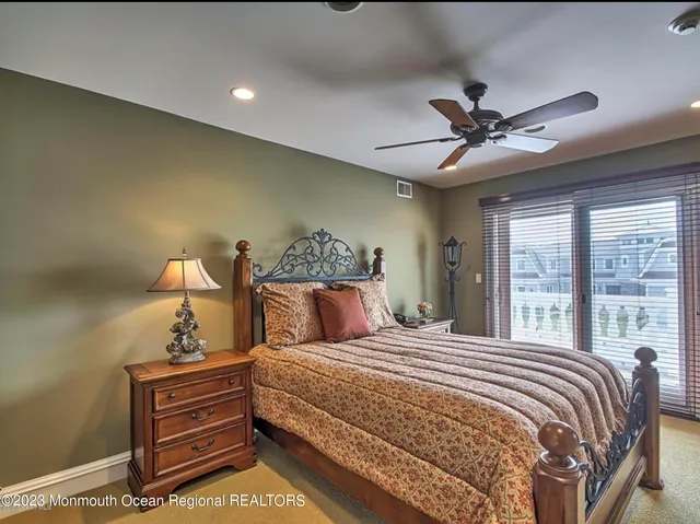 a bathroom with a granite countertop sink toilet mirror and bathtub