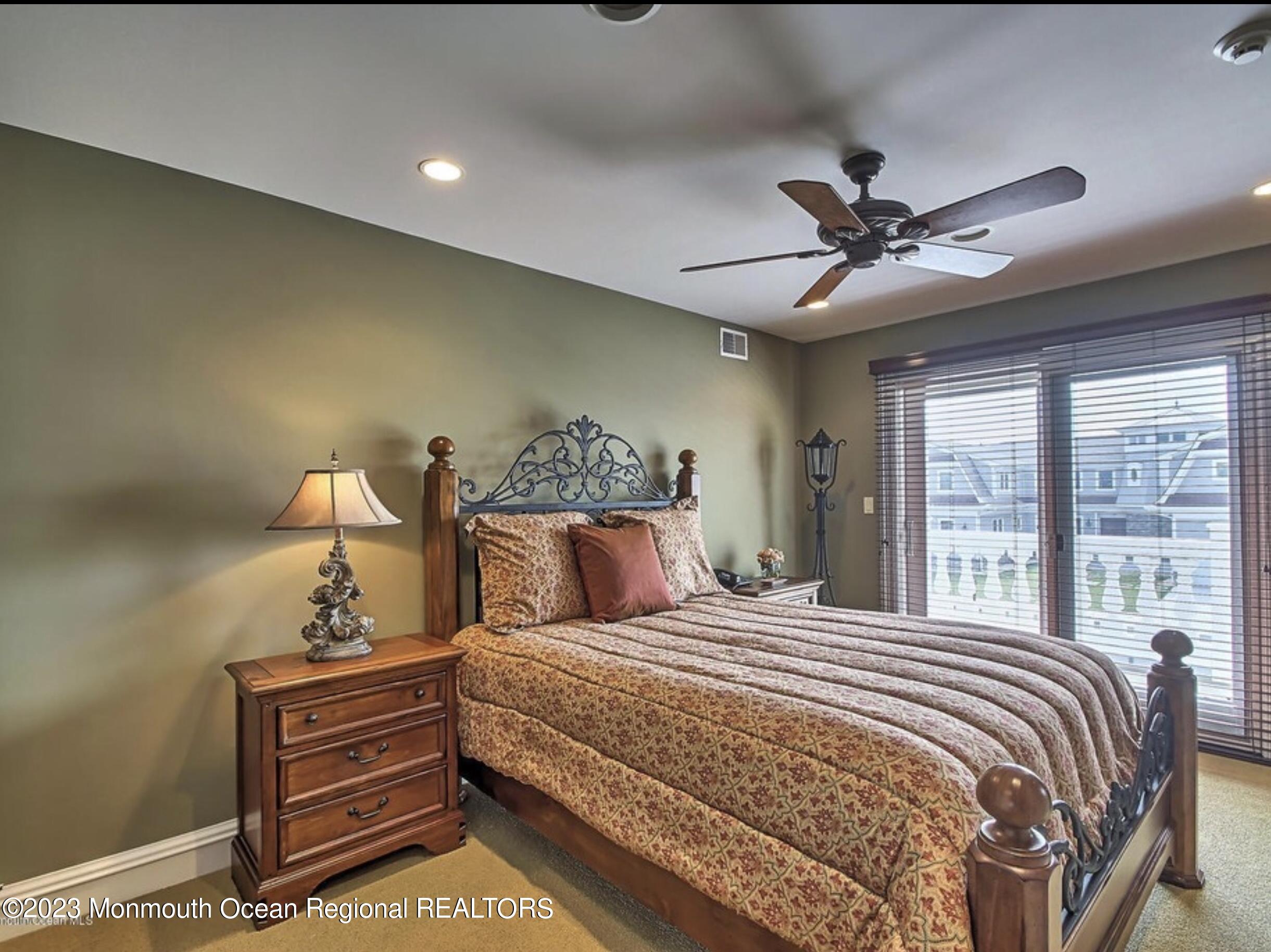 220 Pointe Drive Mantoloking, NJ 08738 - Photo 22 of 30 a bedroom with a bed and a chandelier