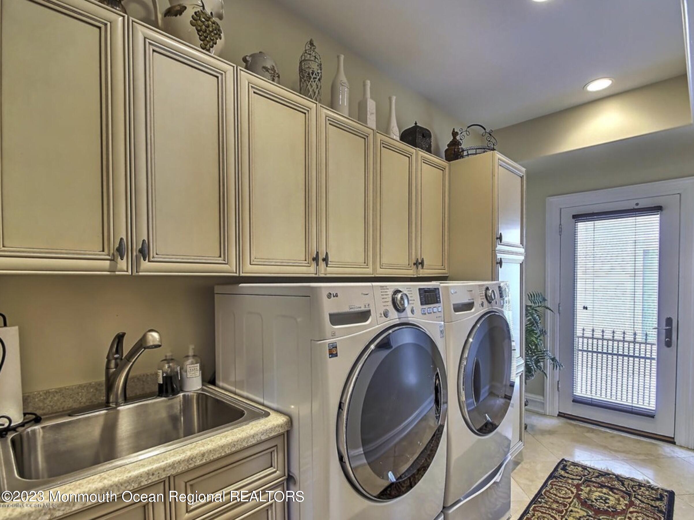220 Pointe Drive Mantoloking, NJ 08738 - Photo 24 of 30 a bathroom with a sink a washer and dryer