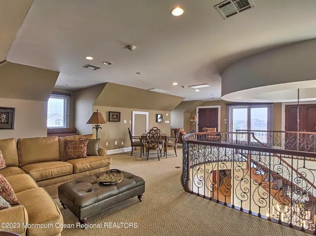 a view of a house with swimming pool and sitting area