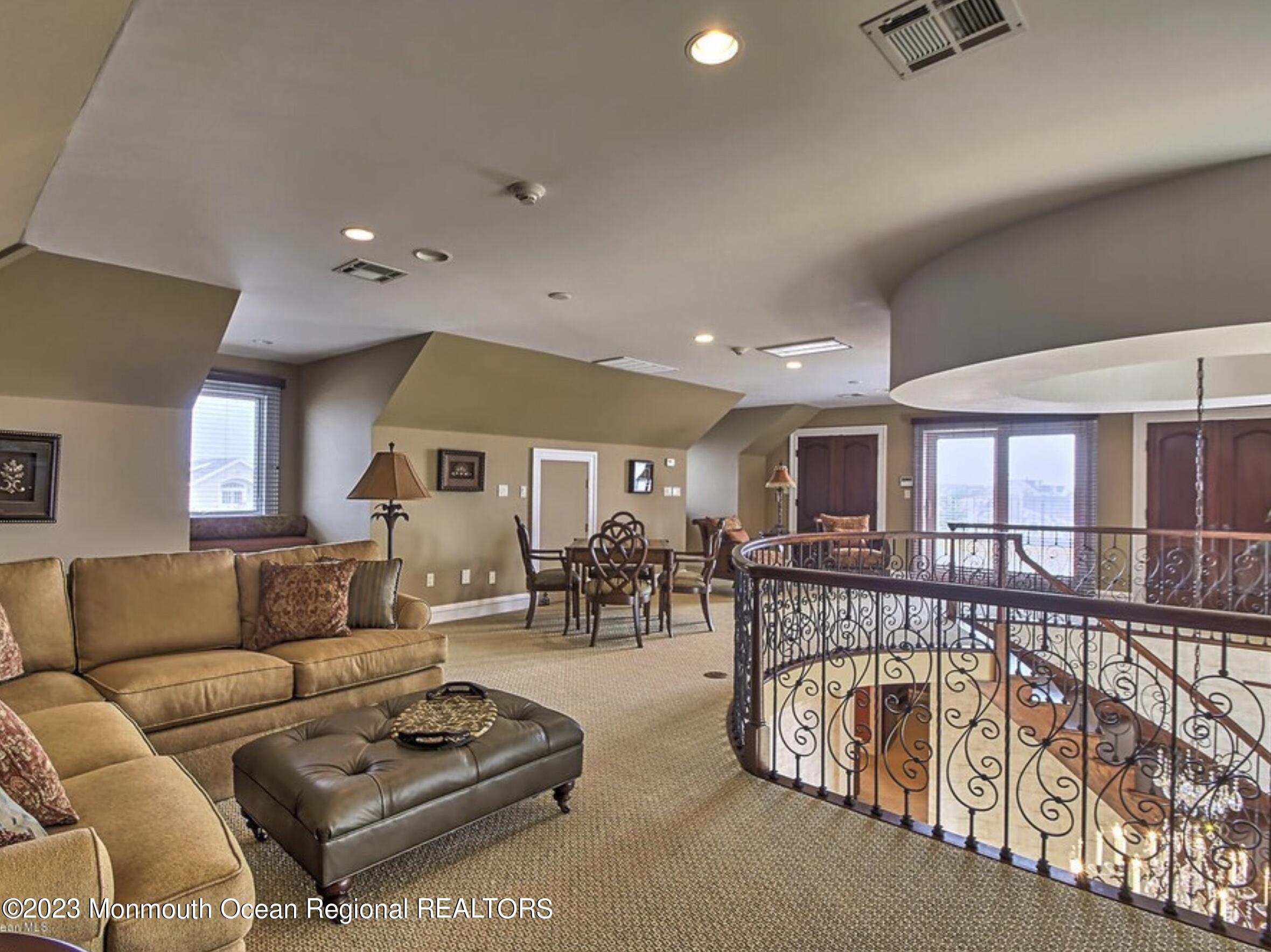 220 Pointe Drive Mantoloking, NJ 08738 - Photo 27 of 30 a living room with furniture a couch and kitchen view