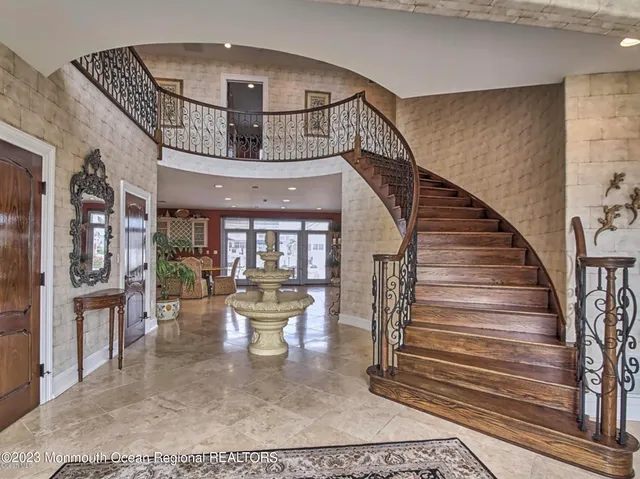 a kitchen with stainless steel appliances granite countertop a kitchen island sink cabinets and wooden floor
