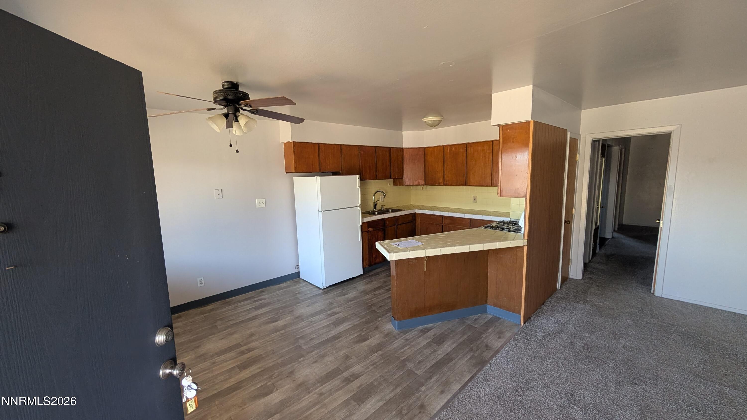 1312 Como Street Carson City, NV 89701 - Photo 2 of 5 a view of a kitchen with a sink and a refrigerator