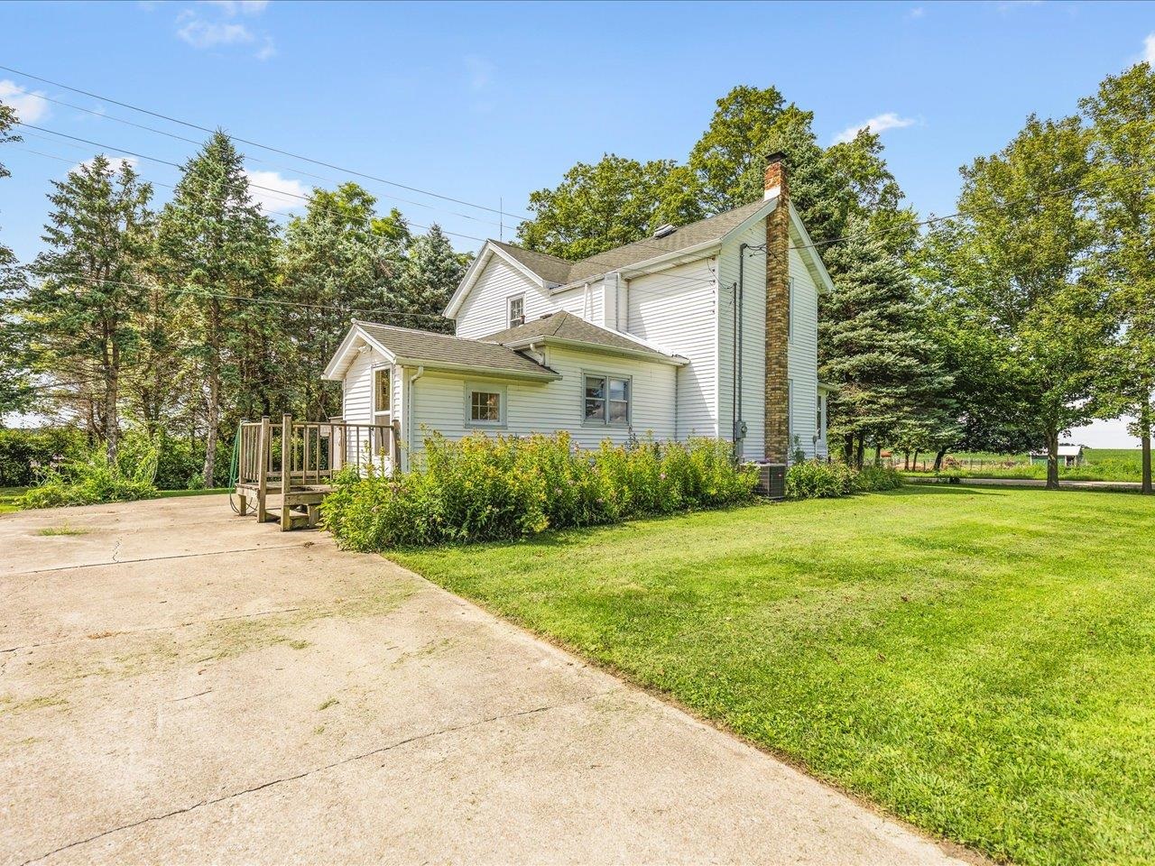 9311 State Line Road Capron, IL 61012 - Photo 2 of 51 a front view of a house with a garden