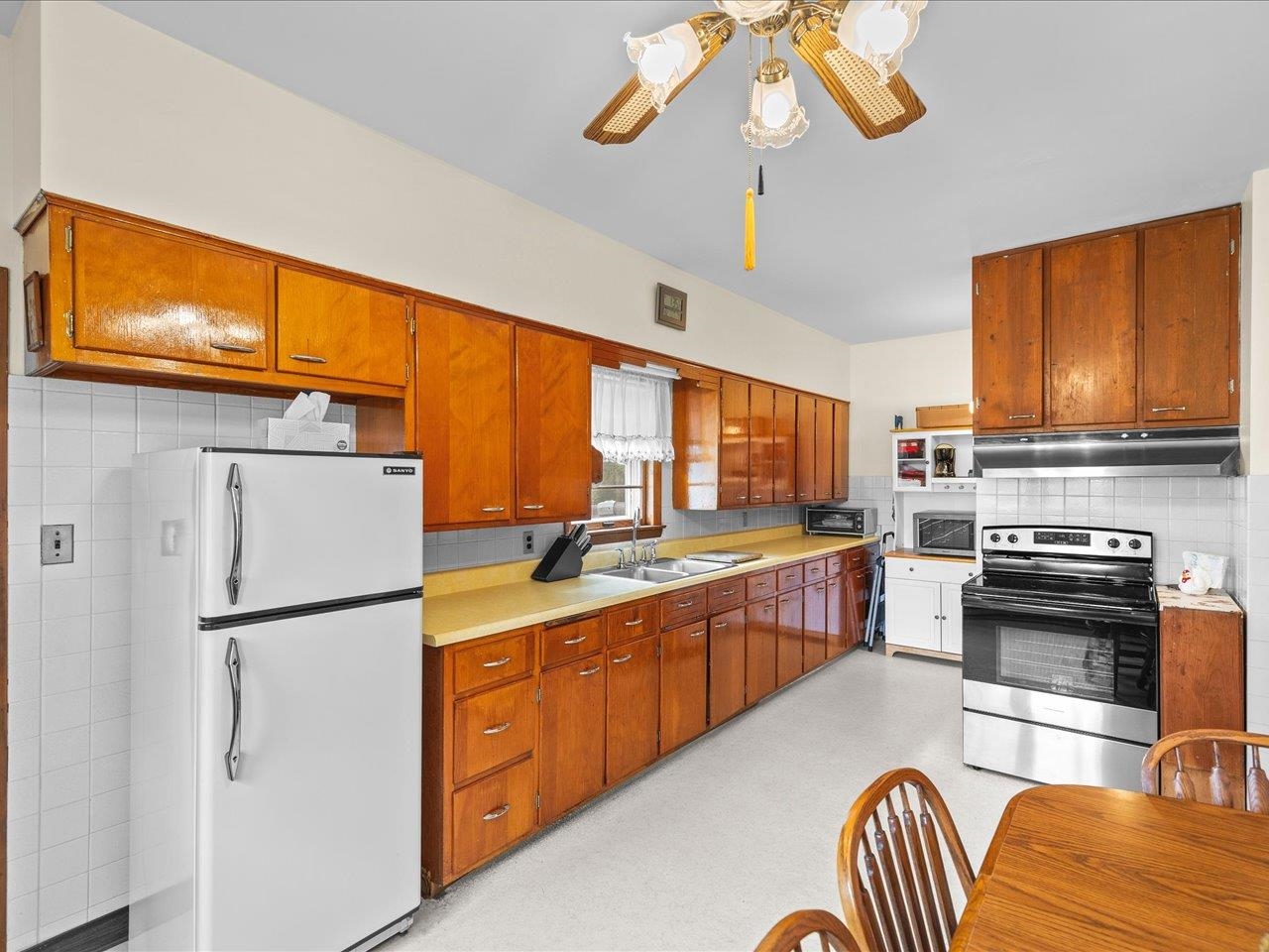 9311 State Line Road Capron, IL 61012 - Photo 25 of 51 a kitchen with stainless steel appliances granite countertop a refrigerator a sink dishwasher a stove and a dining table with wooden floor