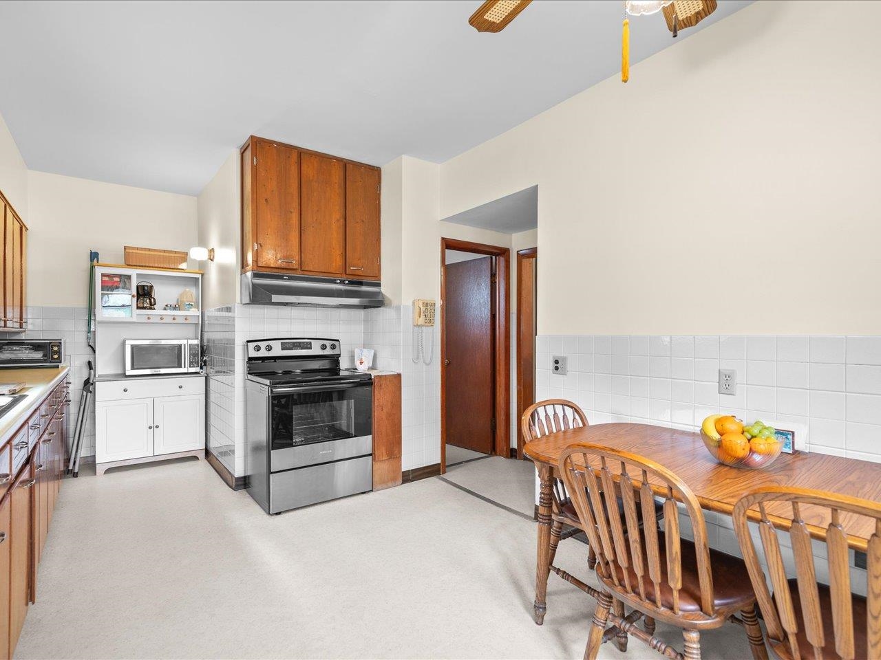 9311 State Line Road Capron, IL 61012 - Photo 27 of 51 a kitchen with stainless steel appliances a stove a chimney a sink and cabinets