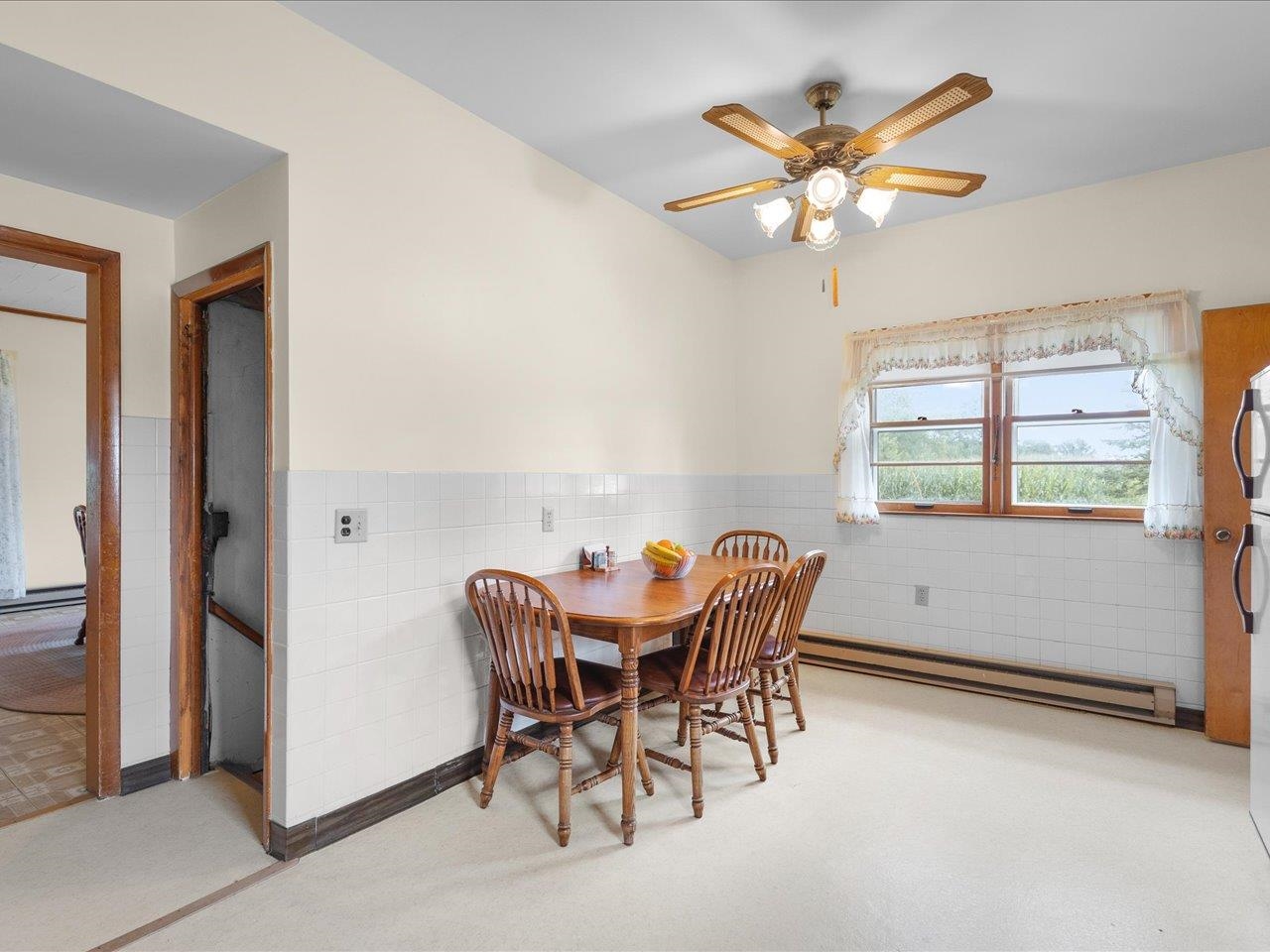 9311 State Line Road Capron, IL 61012 - Photo 28 of 51 a view of a dining room with furniture and chandelier fan