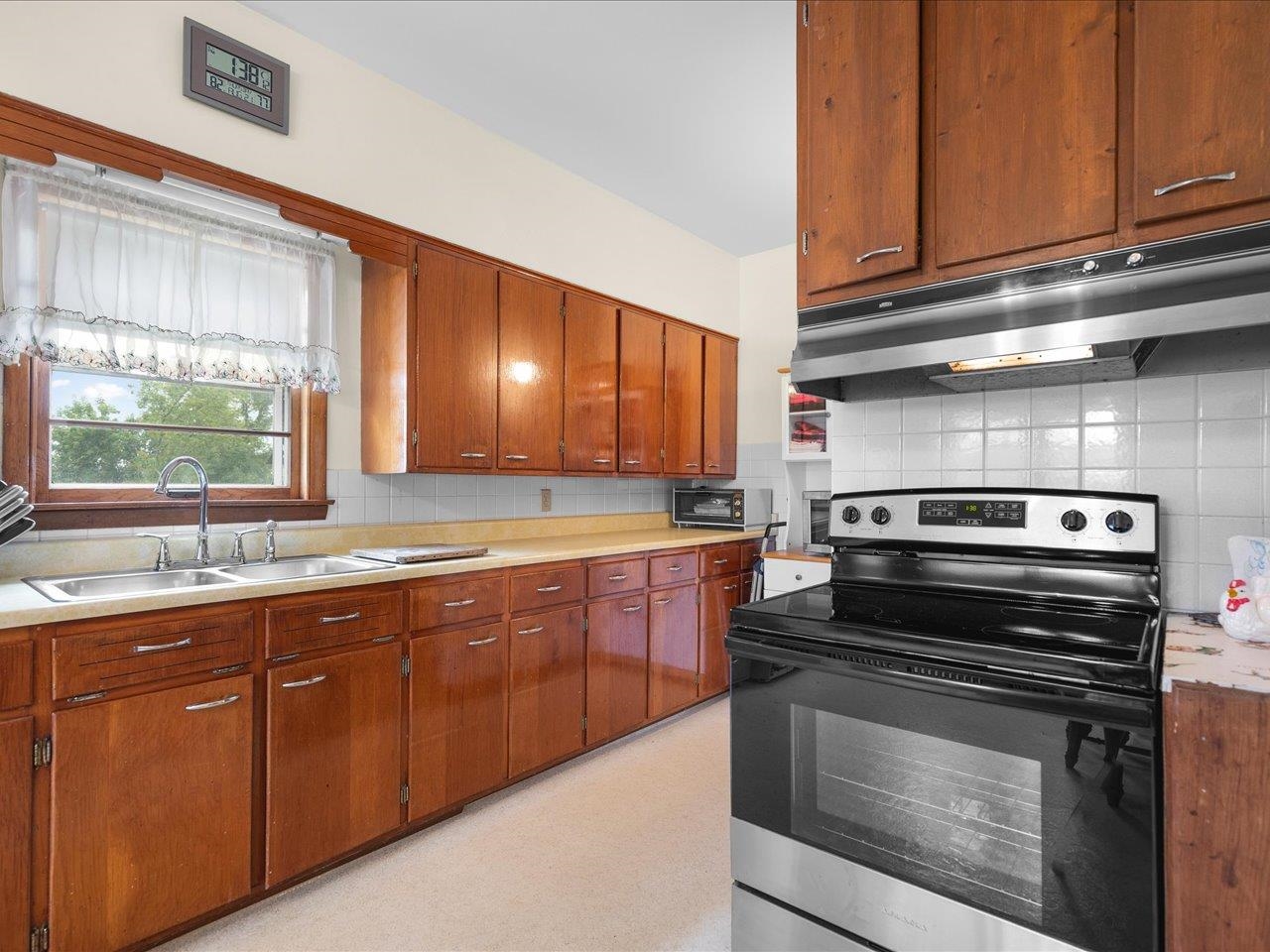9311 State Line Road Capron, IL 61012 - Photo 30 of 51 a kitchen with stainless steel appliances granite countertop wooden cabinets and a stove top oven