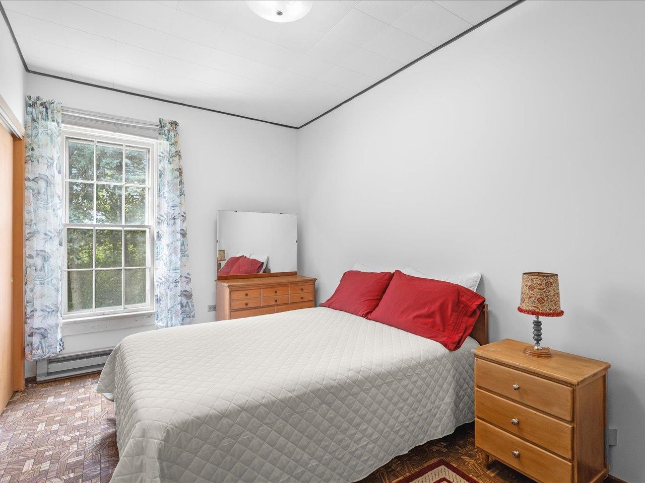 9311 State Line Road Capron, IL 61012 - Photo 33 of 51 a bedroom with a bed and wooden floor