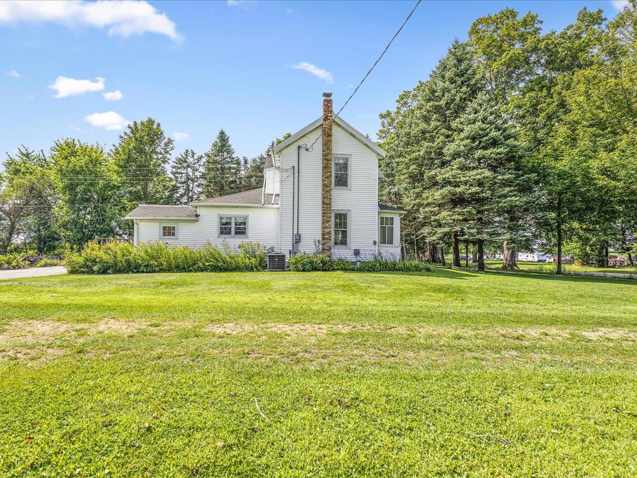 9311 State Line Road Capron, IL 61012 - Photo 4 of 51 a view of a house with a yard and trees