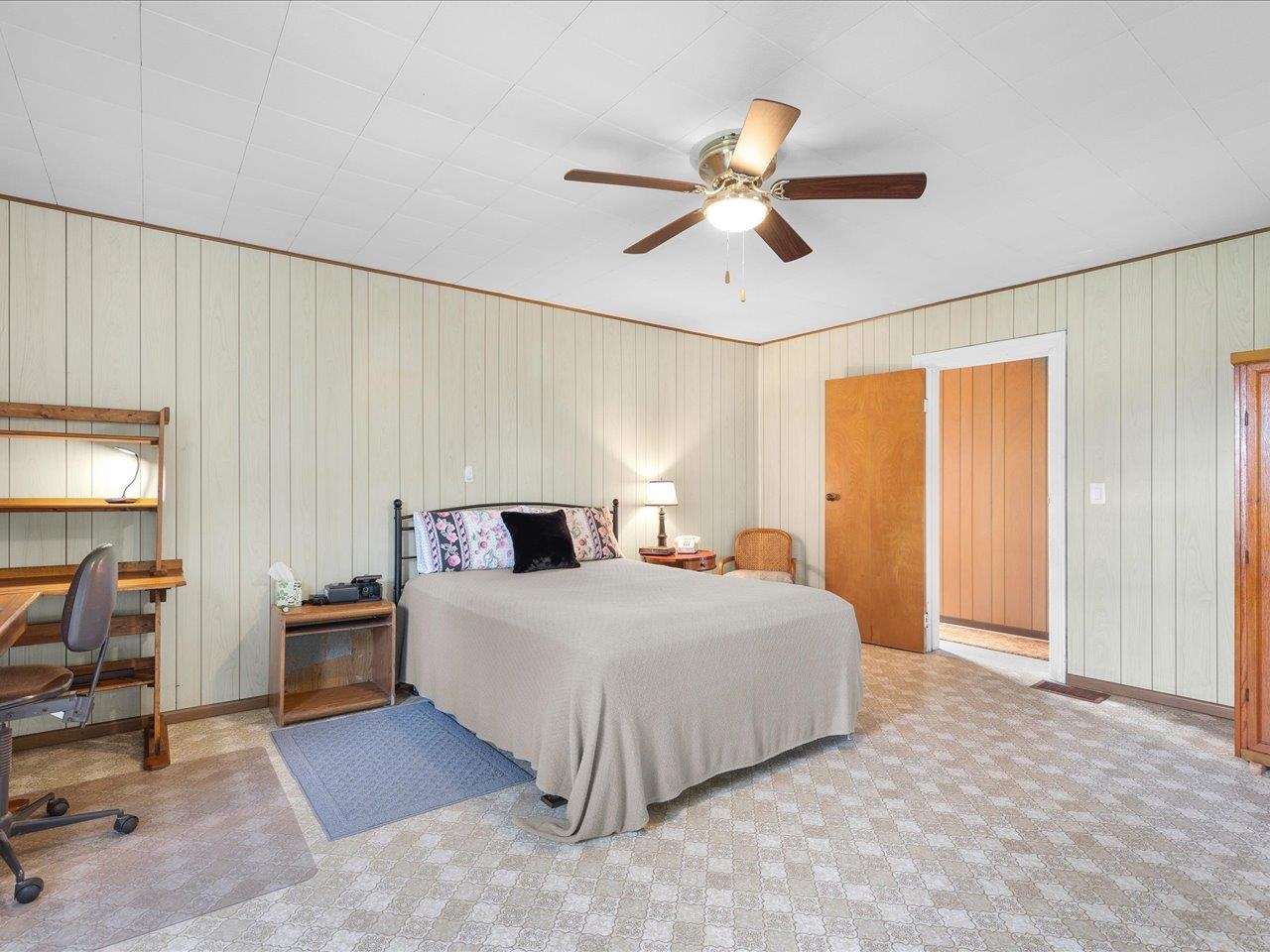 9311 State Line Road Capron, IL 61012 - Photo 42 of 51 a bedroom with a large bed and a chandelier