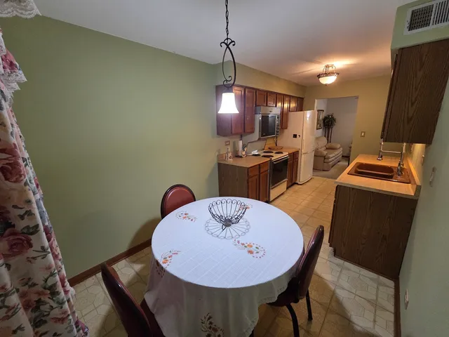 a bathroom with a sink a toilet a mirror and shower