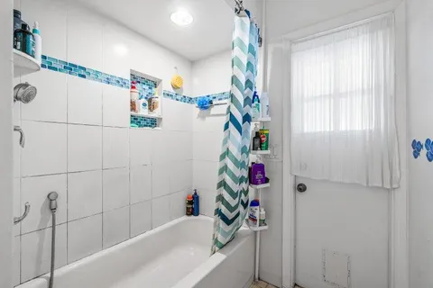 a bathroom with a bathtub and a shower