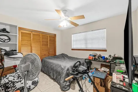 a bedroom with furniture and a window