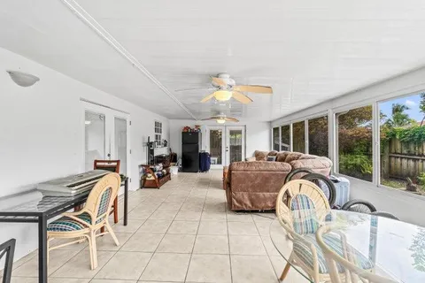 a view of a livingroom with furniture and large windows