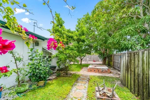 a view of a flower in a yard with a fountain