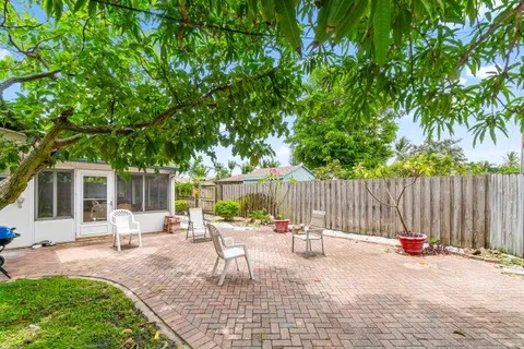 a view of a backyard with a patio and outdoor seating