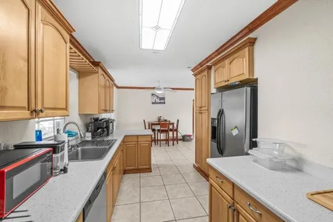 a kitchen with a sink a stove and cabinets