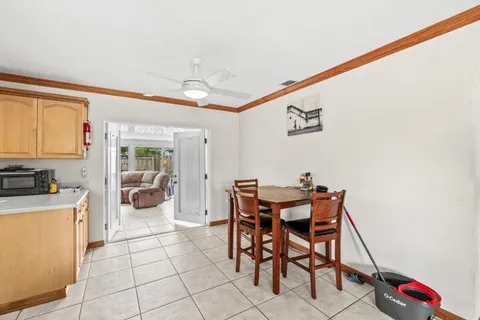 a view of a dining room with furniture and a kitchen