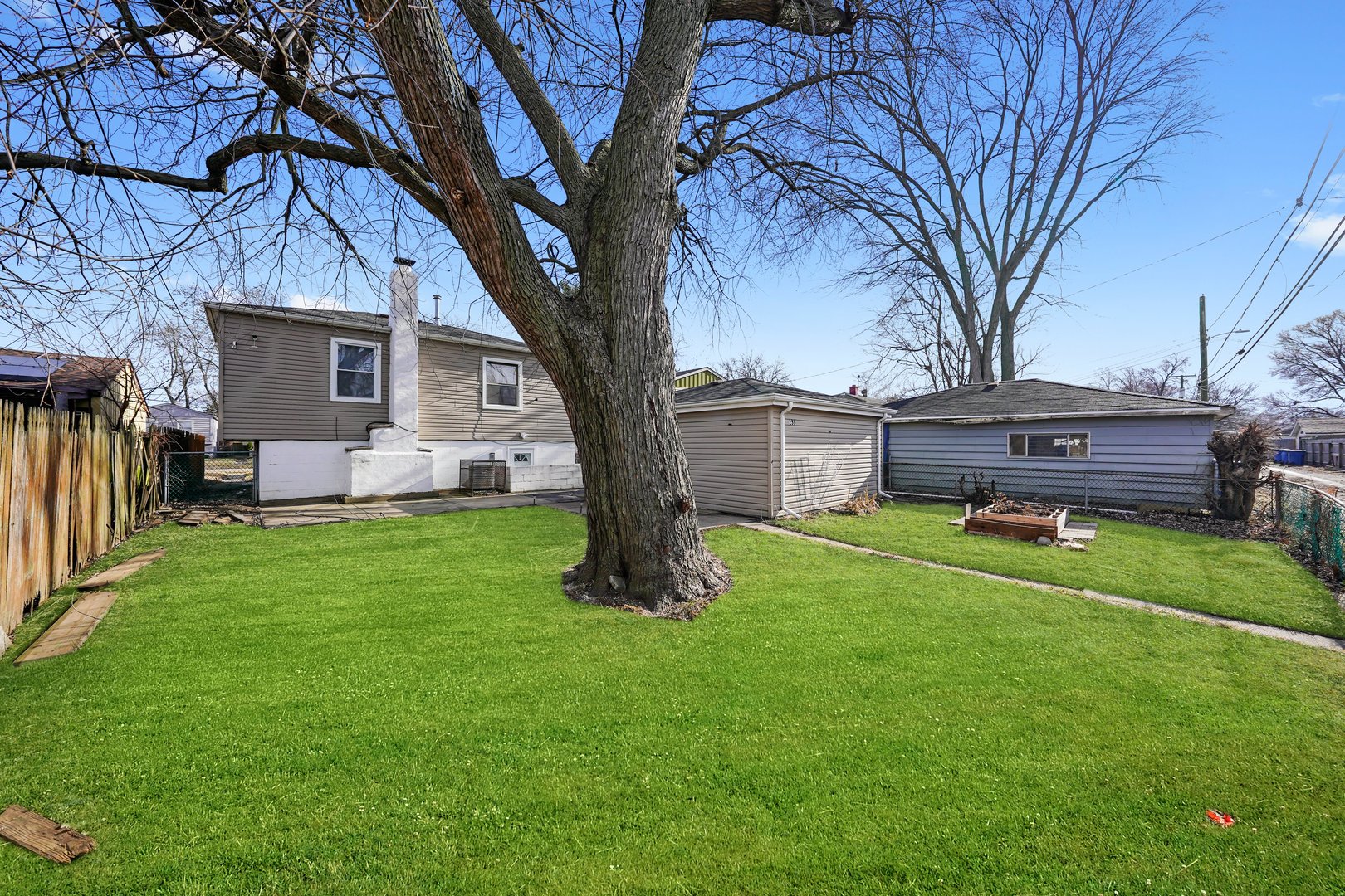 298 Merrill Avenue Calumet City, IL 60409 - Photo 5 of 13 a front view of a house with garden