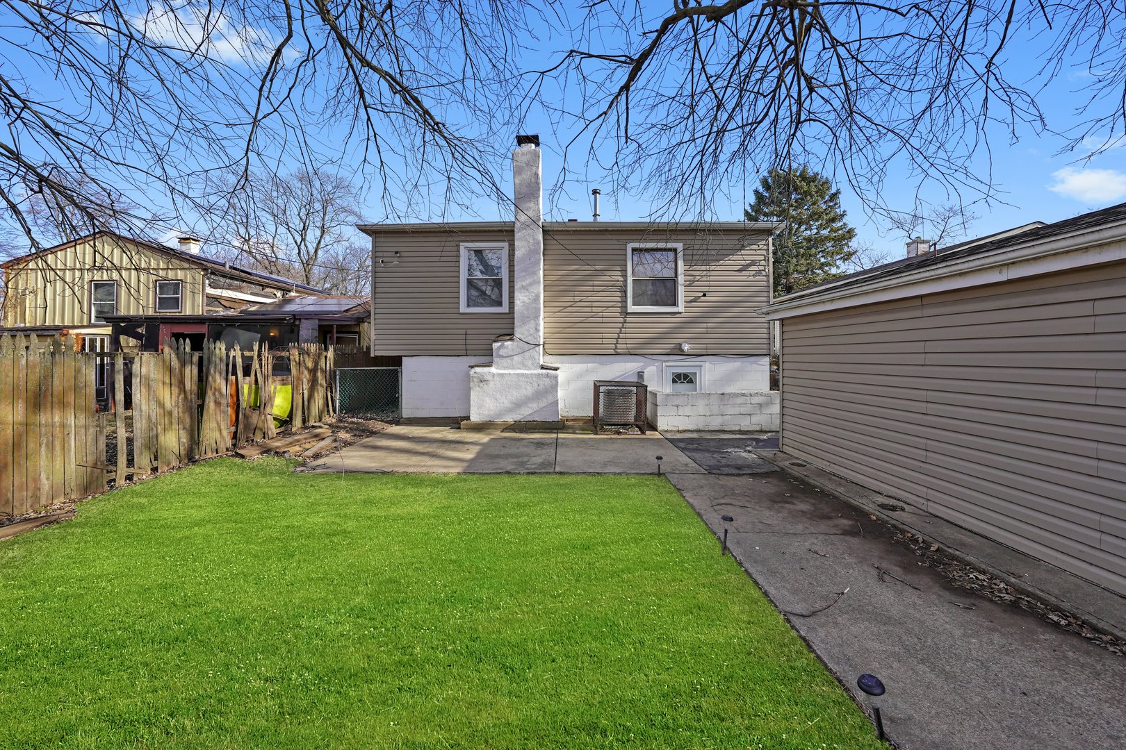 298 Merrill Avenue Calumet City, IL 60409 - Photo 6 of 13 a view of a house with backyard and a tree