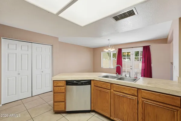 a metallic refrigerator freezer sitting in a kitchen