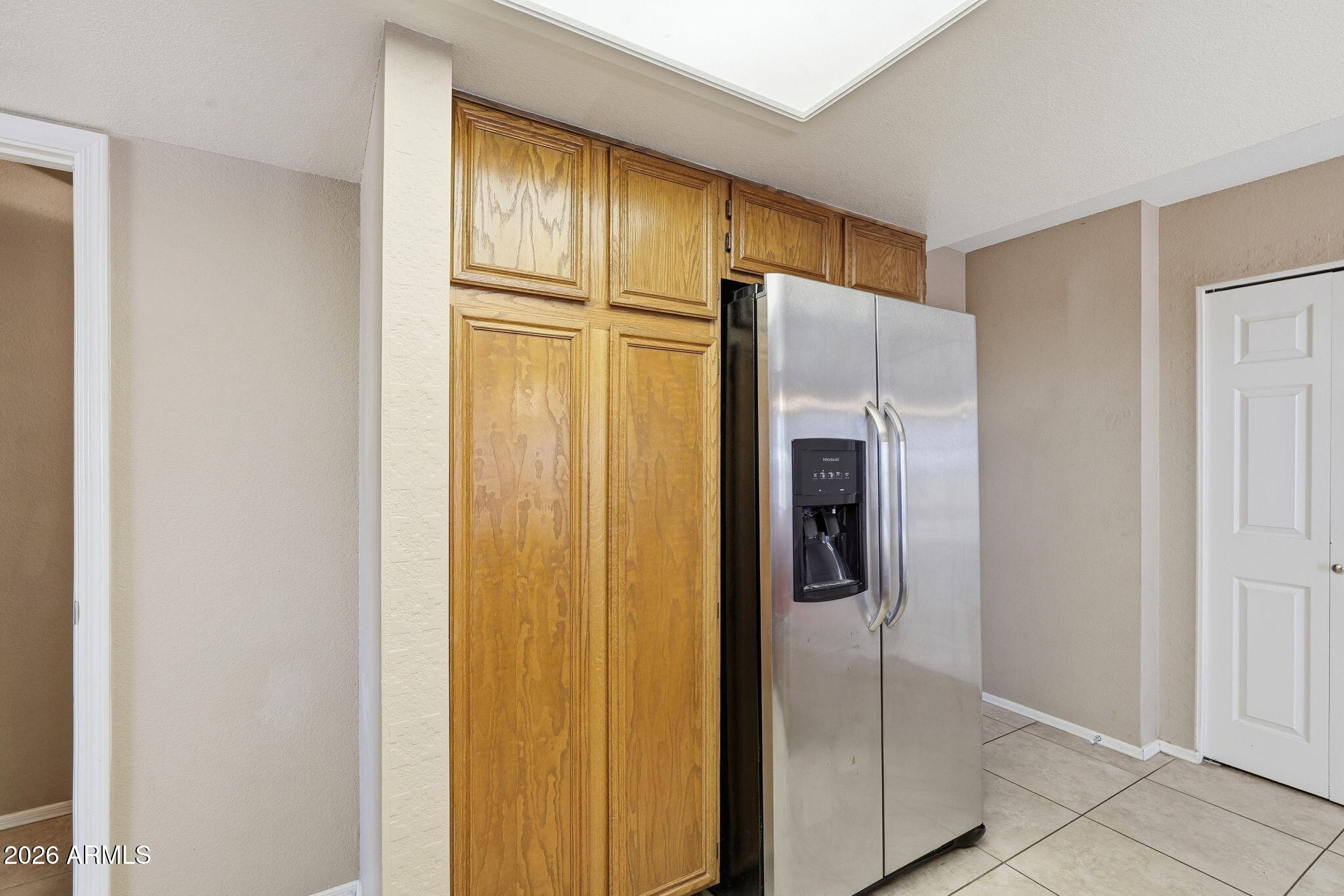 1229 North Alma School Road, Unit 1 Mesa, AZ 85201 - Photo 15 of 38 a metallic refrigerator freezer sitting in a kitchen