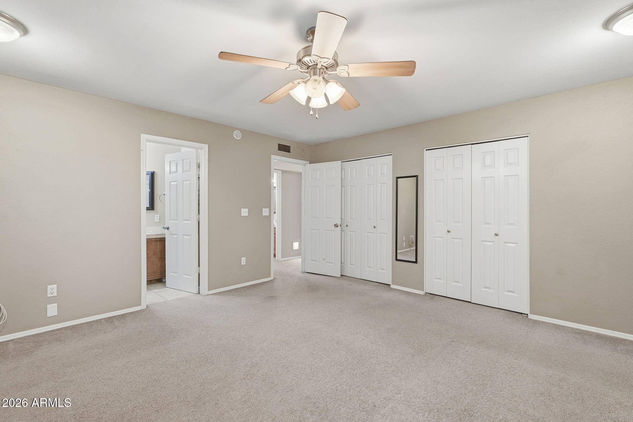 1229 North Alma School Road, Unit 1 Mesa, AZ 85201 - Photo 18 of 38 a view of an empty room with a ceiling fan