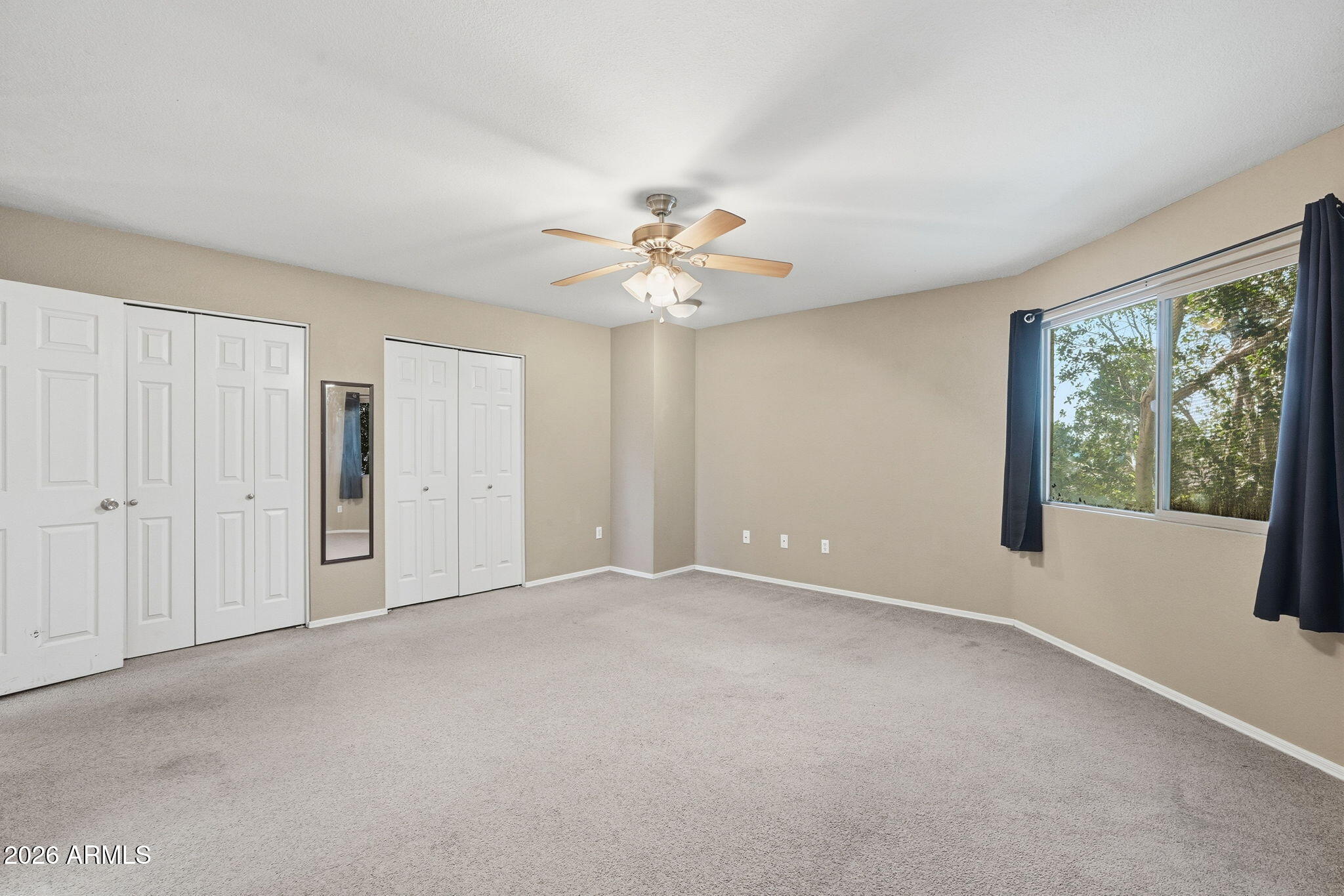1229 North Alma School Road, Unit 1 Mesa, AZ 85201 - Photo 19 of 38 a view of an empty room with a window