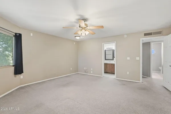 an empty room with a chandelier fan