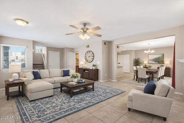 a living room with furniture a rug and a chandelier