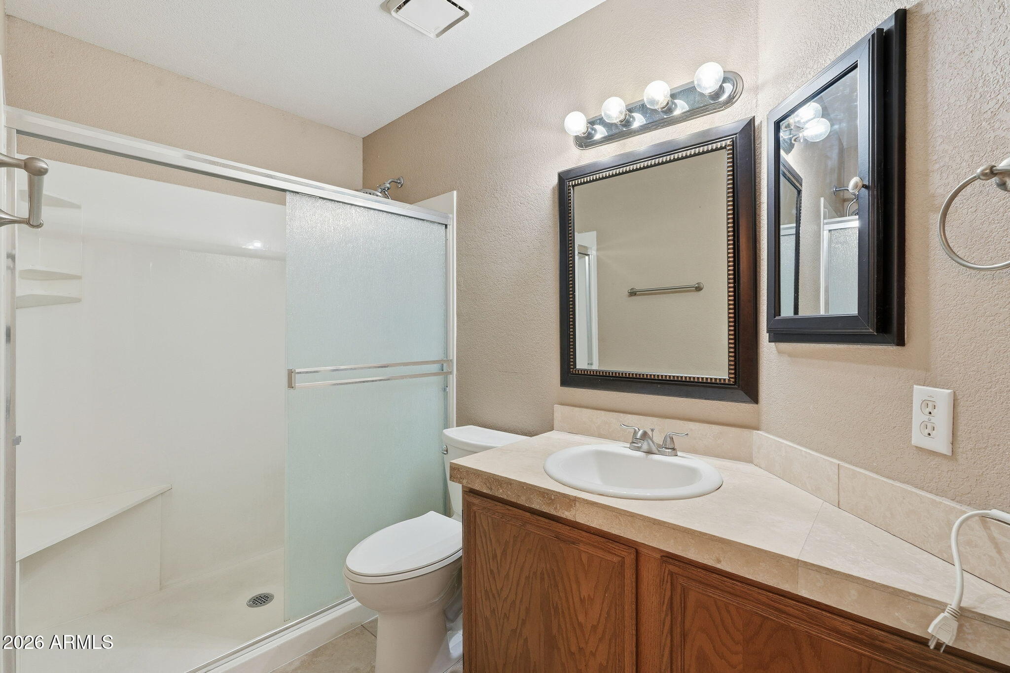 1229 North Alma School Road, Unit 1 Mesa, AZ 85201 - Photo 21 of 38 a bathroom with a granite countertop sink toilet and shower
