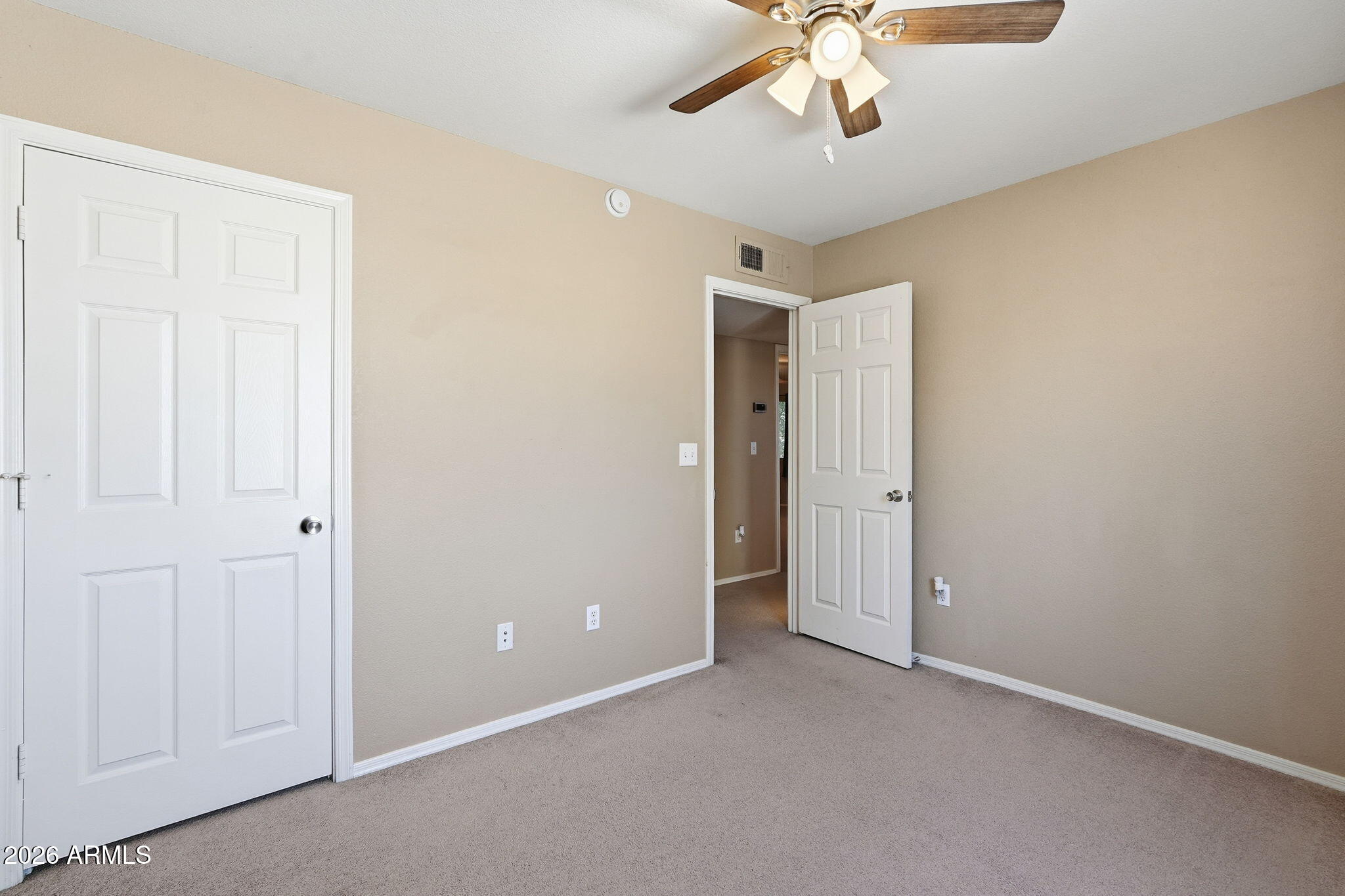 1229 North Alma School Road, Unit 1 Mesa, AZ 85201 - Photo 22 of 38 an empty room with a chandelier fan