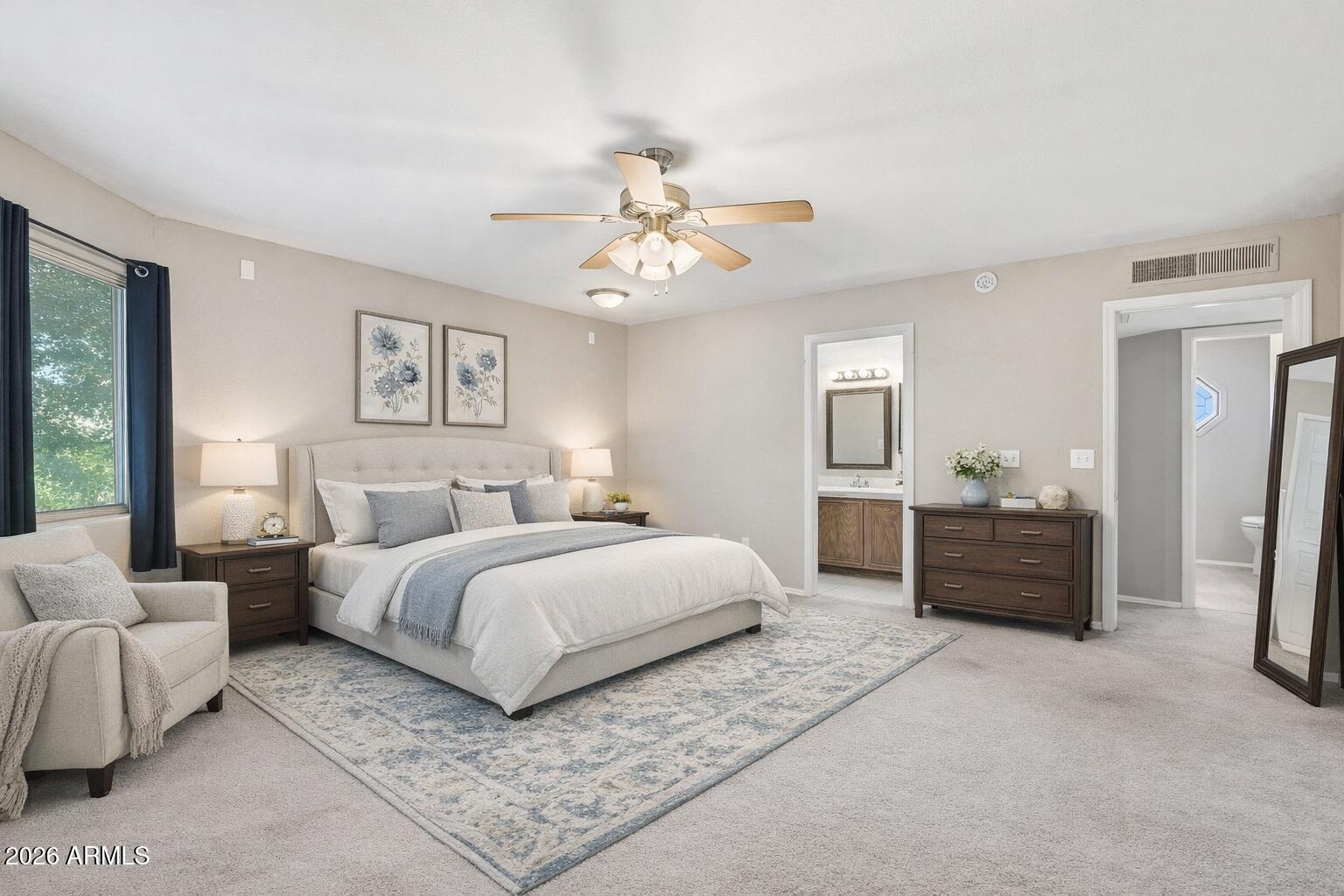 1229 North Alma School Road, Unit 1 Mesa, AZ 85201 - Photo 4 of 38 a spacious bedroom with a bed and a couch