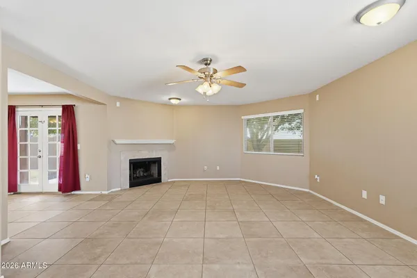 an empty room with fan and glass door