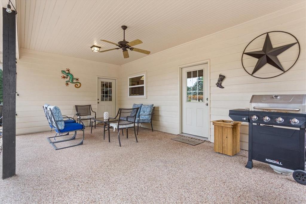 111 Spring Creek Street Waco, TX 76705 - Photo 32 of 40 Covered patio featuring an exposed aggregate concrete floor, beadboard ceiling, and ceiling fan with integrated lighting