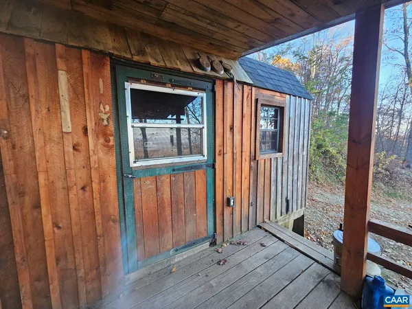 a view of a porch with wooden floor and outdoor space