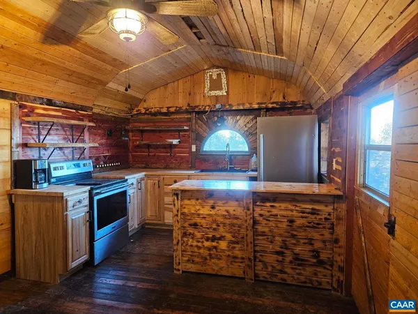 a kitchen with stainless steel appliances wooden cabinets and a stove