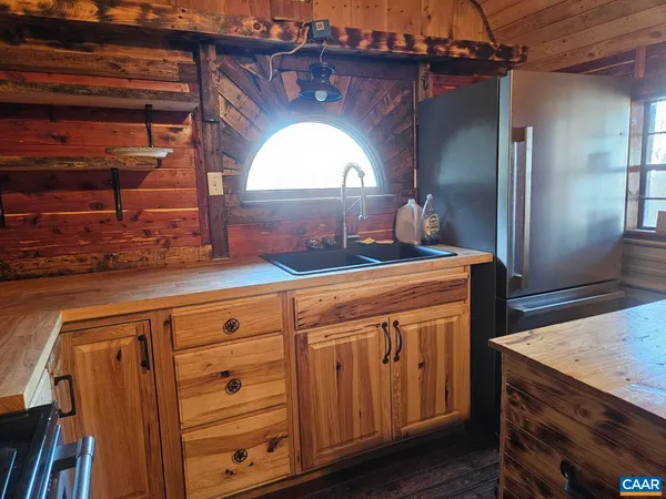 a view of a hallway with granite countertop a stove a washer and dryer