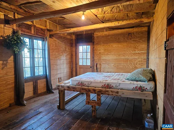 a view of a patio with table and chairs with wooden floor and fence