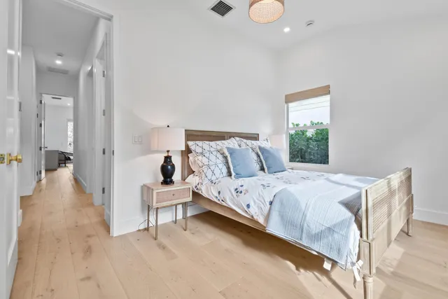 a spacious bedroom with a bed and a window