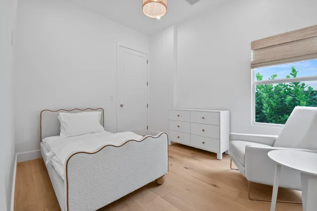 a bed room with a bed and a chair