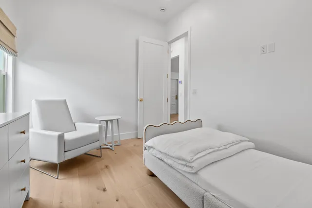 a bedroom with a bed and a couch