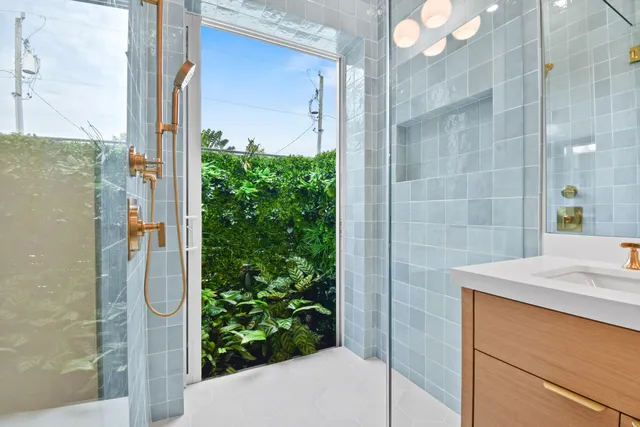 a bathroom with a shower and a sink