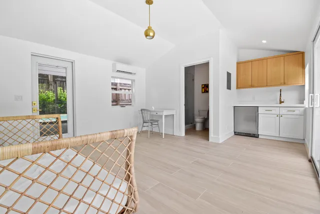 a view of a bedroom with furniture and window