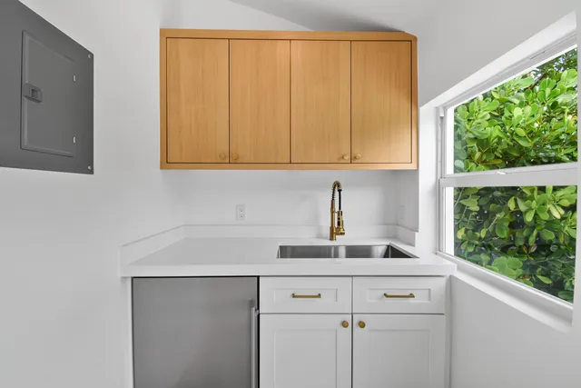 a kitchen with a sink cabinets and a window