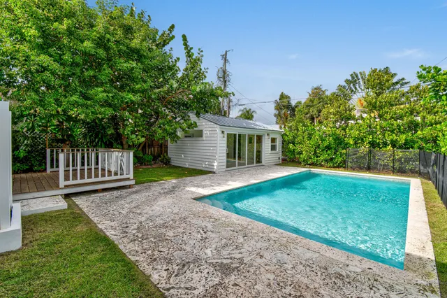 a view of a house with a yard and a garden