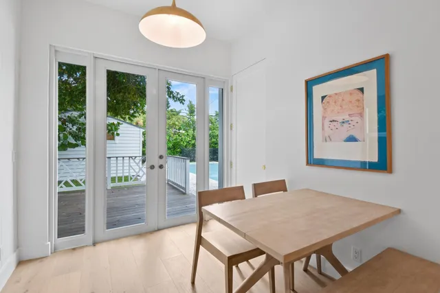 a view of a dining room with furniture large windows and wooden floor