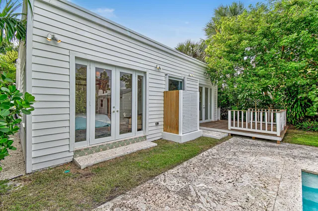 a view of a house with a yard and stairs